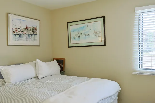 a bedroom with a bed and a wall painting