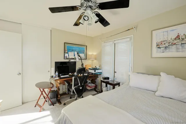 a bedroom with a bed a desk and chair