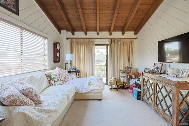 a bedroom with furniture and a flat screen tv