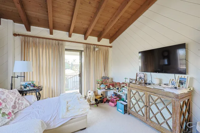 a bedroom with furniture and a flat screen tv