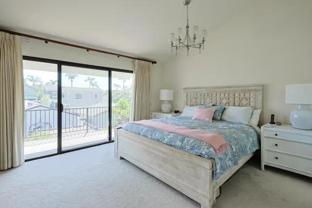 a bedroom with a large window and a bed