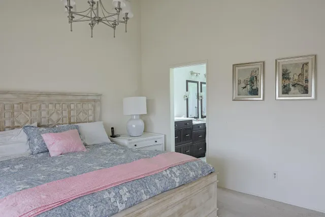 a spacious bathroom with a granite countertop sink and a mirror