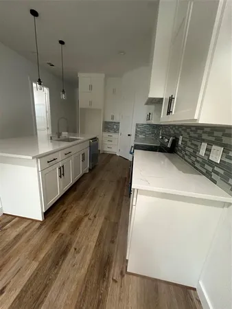 a view of kitchen with wooden floor