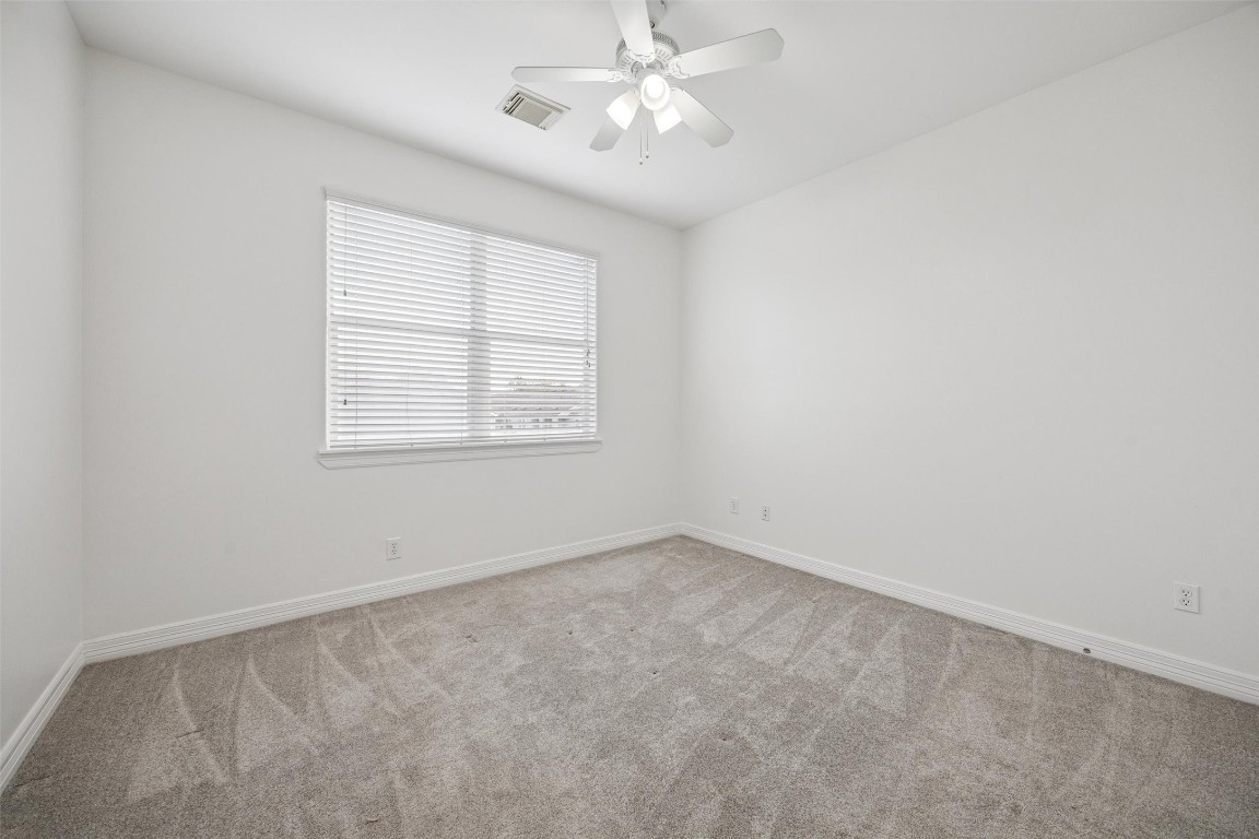 3322 Garden Crest Lane Houston, TX 77018 - Photo 22 of 31 This secondary bedroom features a large window with blinds, allowing natural light to fill the space, and a ceiling fan for comfort.