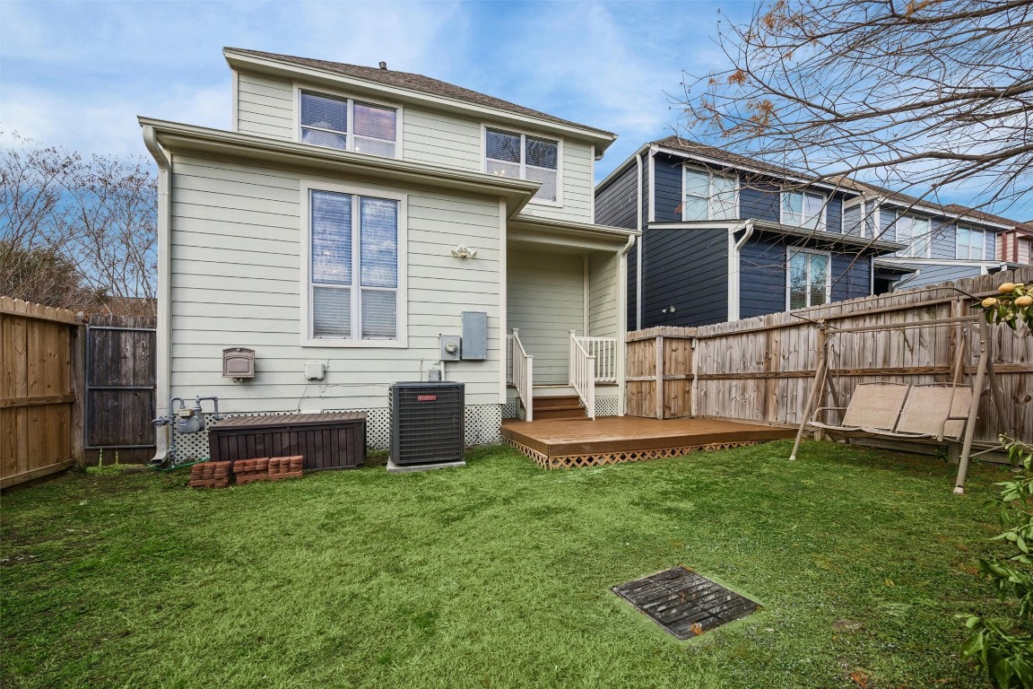 3322 Garden Crest Lane Houston, TX 77018 - Photo 24 of 31 Charming backyard with a small wooden deck, fenced for privacy. Features a cozy swing and ample space for outdoor activities.