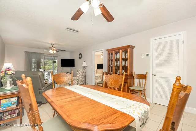 a bedroom with a bed a couch and wooden floor