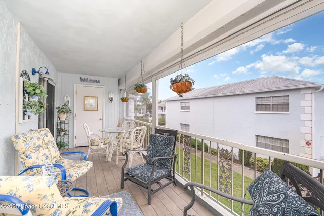 a balcony with furniture and painting on the wall