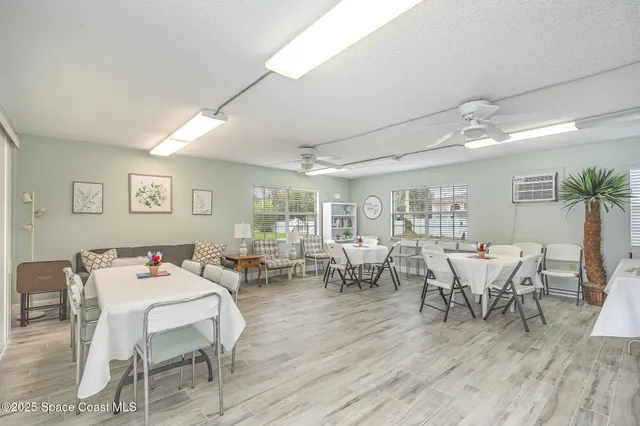 a dining room with furniture and wooden floor