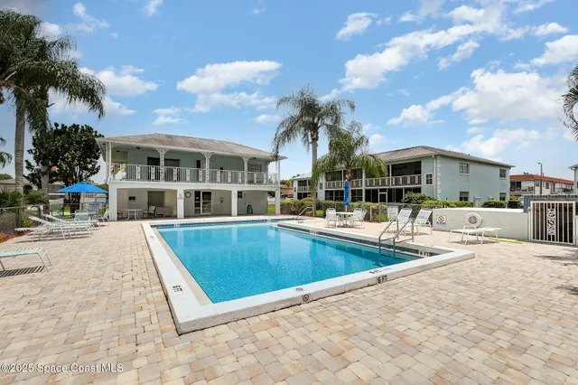 a view of a patio with swimming pool table and chairs