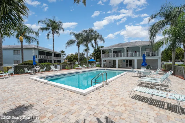 a view of a house with swimming pool and sitting area
