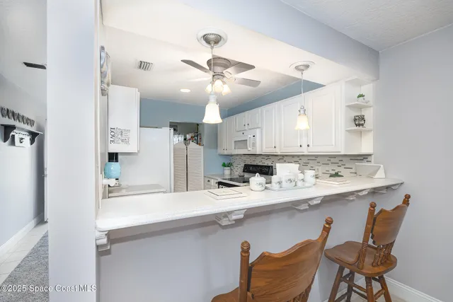 a kitchen with a sink cabinets and stainless steel appliances