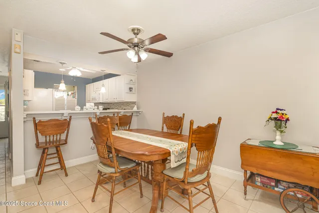 a view of a dining room with furniture and a chandelier