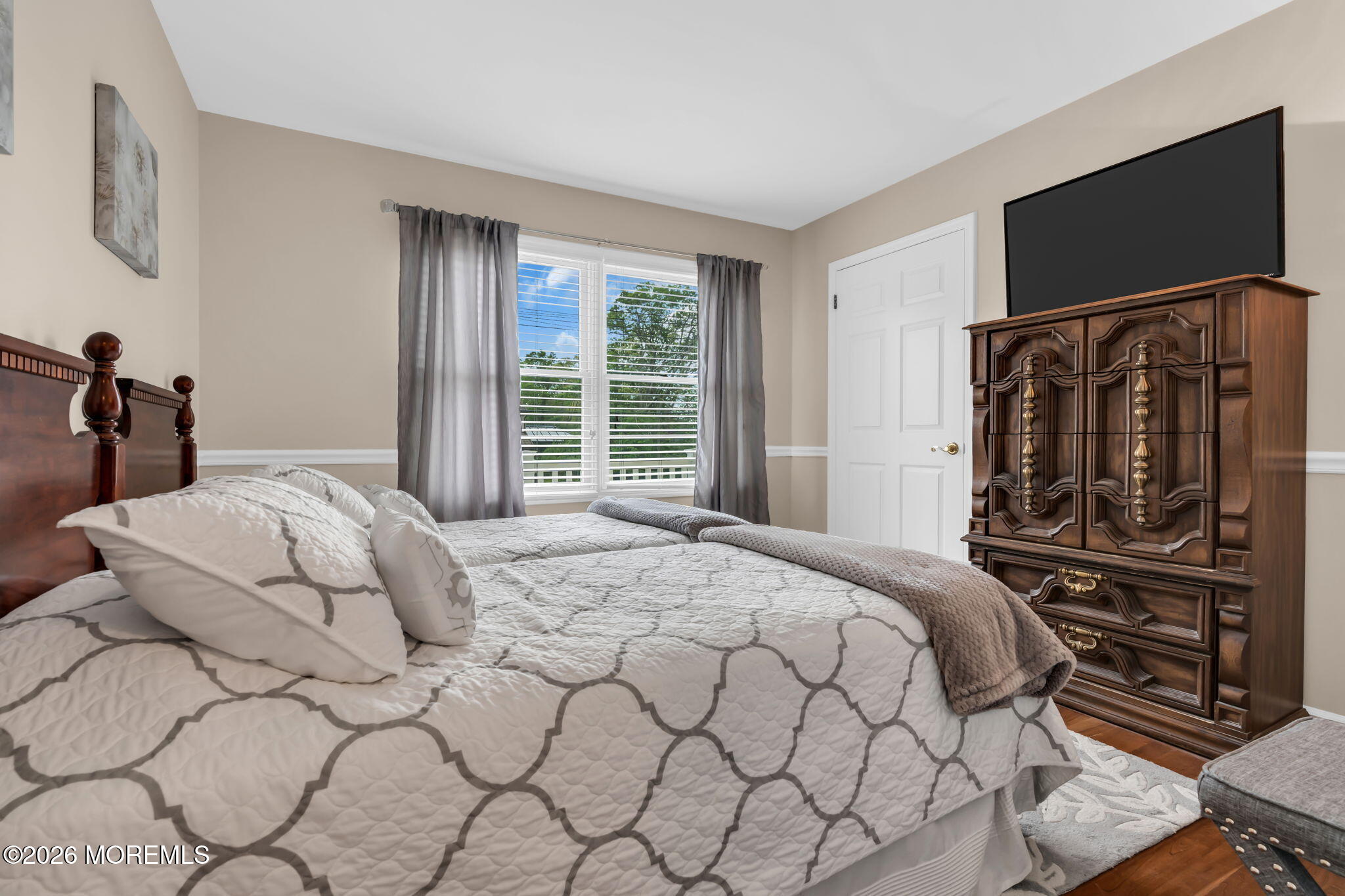 657 Valley Road Brielle, NJ 08730 - Photo 26 of 44 a bedroom with a bed and a flat tv screen