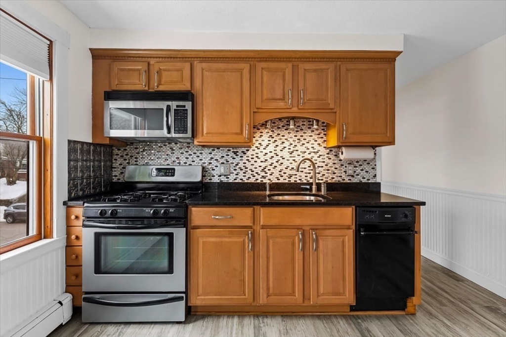 15 Hillock Street, Unit 2 Boston, MA 02131 - Photo 11 of 33 a kitchen with granite countertop a stove and a sink