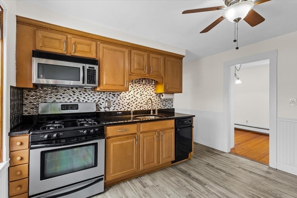 15 Hillock Street, Unit 2 Boston, MA 02131 - Photo 12 of 33 a kitchen with stainless steel appliances granite countertop a stove and a microwave