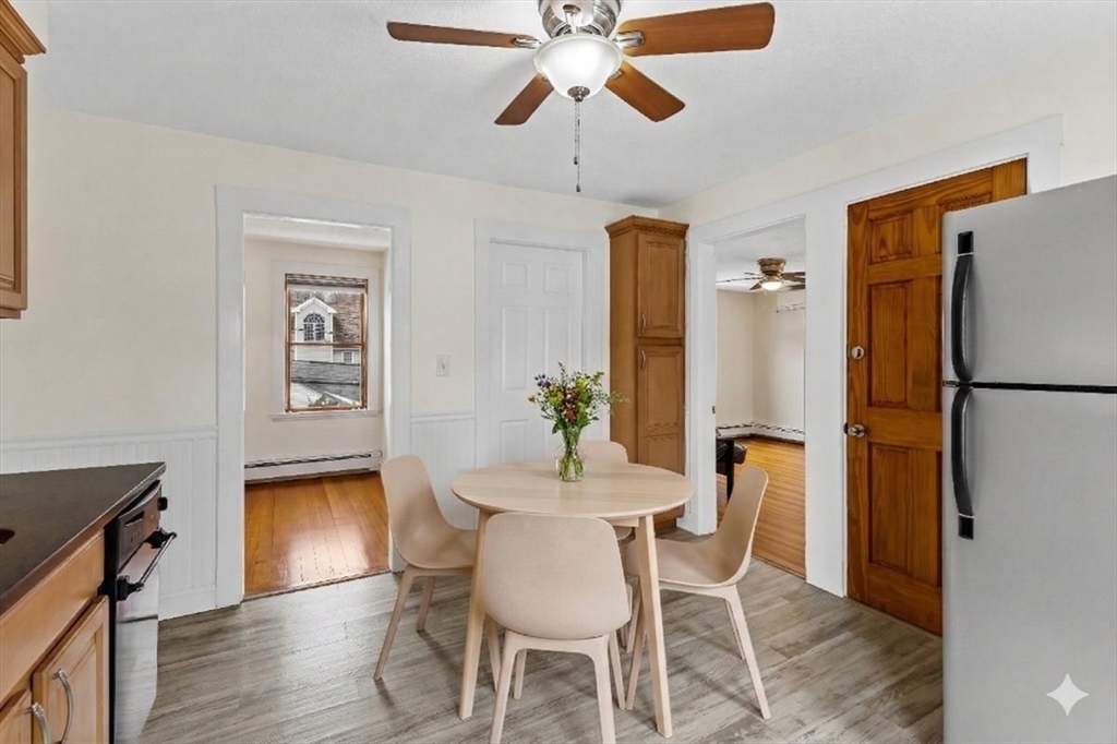 15 Hillock Street, Unit 2 Boston, MA 02131 - Photo 13 of 33 a dining room with furniture a chandelier and wooden floor