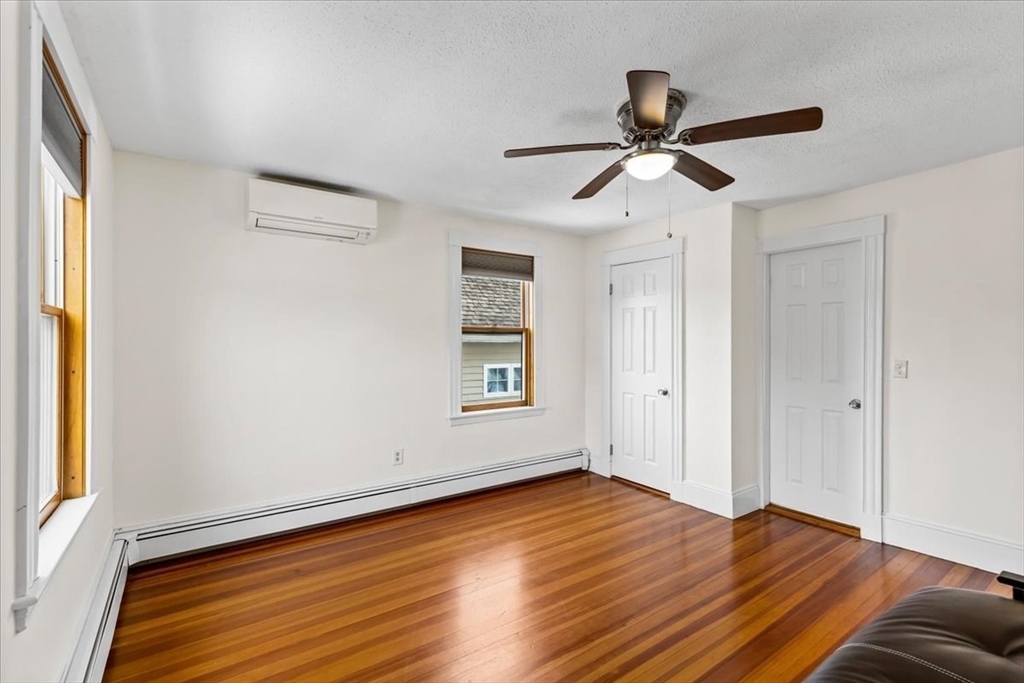 15 Hillock Street, Unit 2 Boston, MA 02131 - Photo 18 of 33 a view of empty room with wooden floor and fan