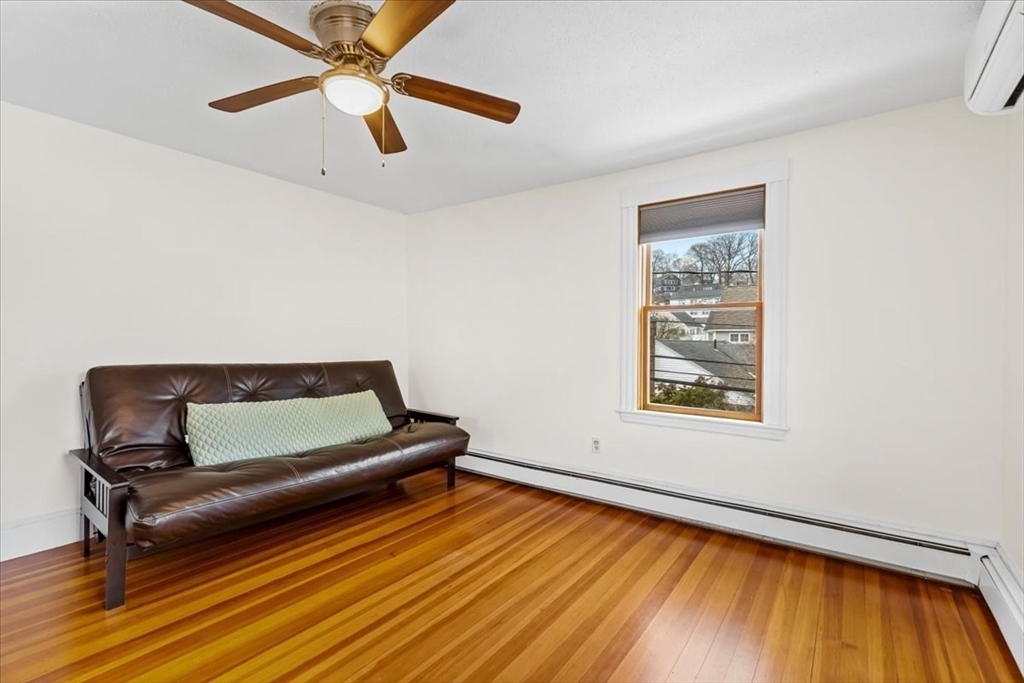 15 Hillock Street, Unit 2 Boston, MA 02131 - Photo 19 of 33 a living room with a bed furniture and a window