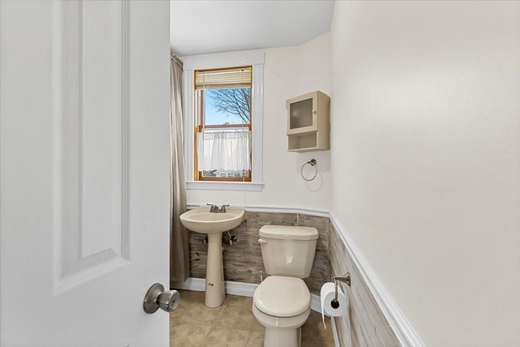 15 Hillock Street, Unit 2 Boston, MA 02131 - Photo 22 of 33 a white toilet sitting next to a bathroom sink