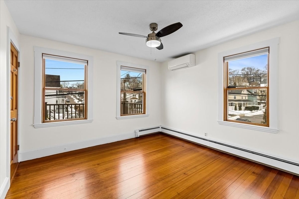 15 Hillock Street, Unit 2 Boston, MA 02131 - Photo 6 of 33 a view of a room with window and wooden floor