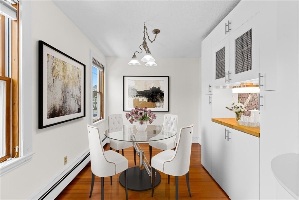 15 Hillock Street, Unit 2 Boston, MA 02131 - Photo 7 of 33 a dining room with wooden floor and furniture
