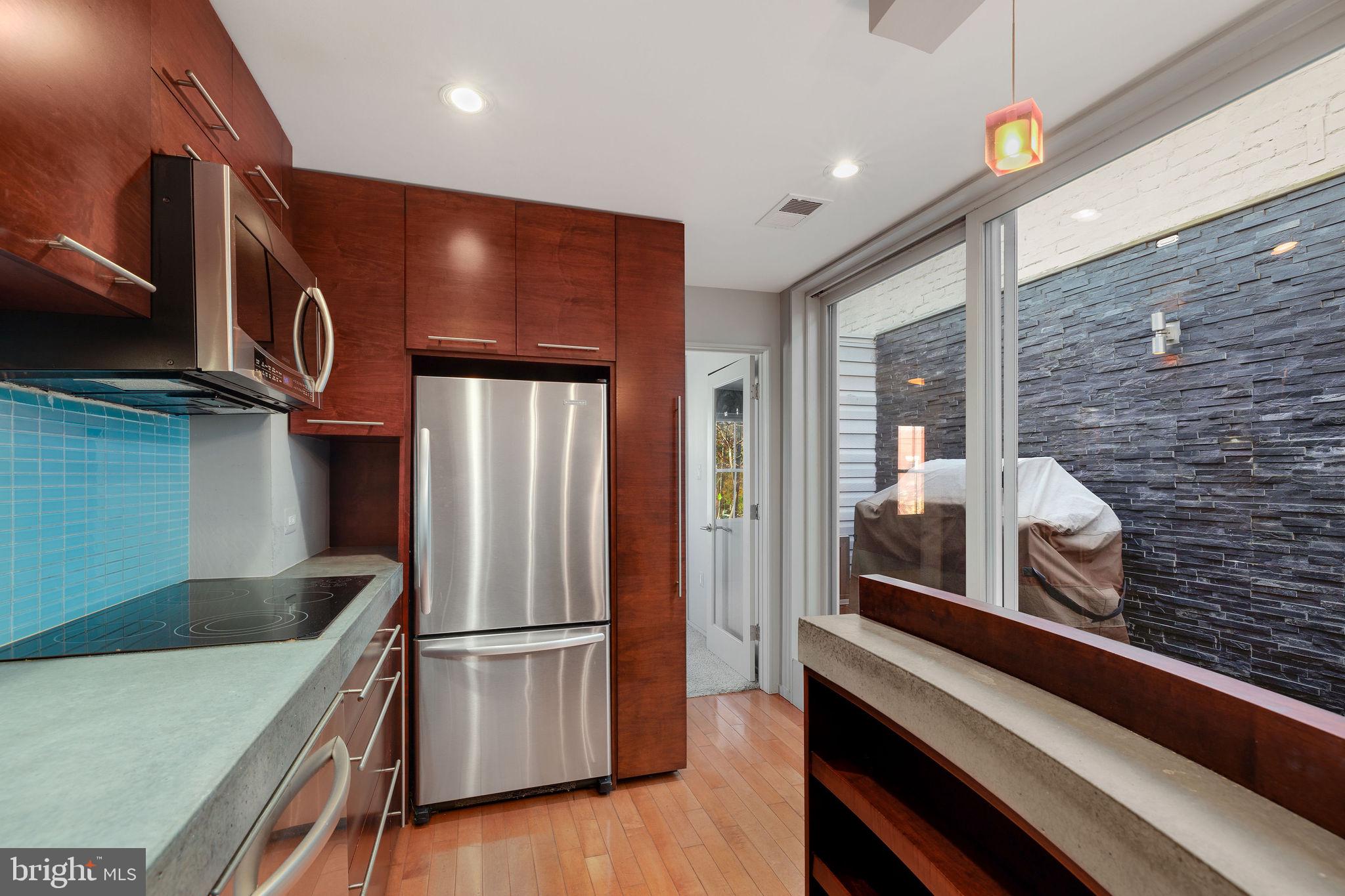 721 D Street Northeast Washington, DC 20002 - Photo 15 of 35 a kitchen with stainless steel appliances granite countertop a refrigerator and a stove