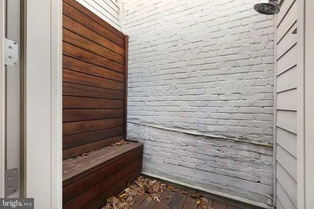 a view of a balcony with wooden floor and potted plants