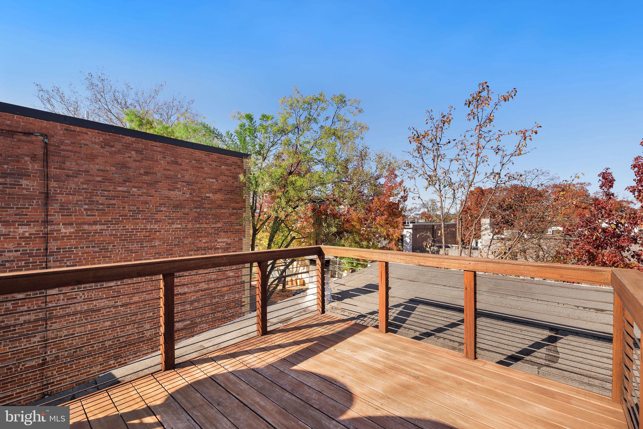 721 D Street Northeast Washington, DC 20002 - Photo 28 of 35 a view of a balcony with wooden floor and potted plants