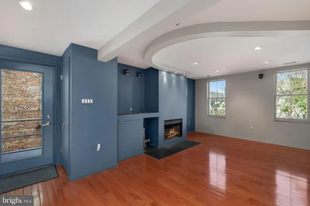 a view of empty room with a fireplace and window