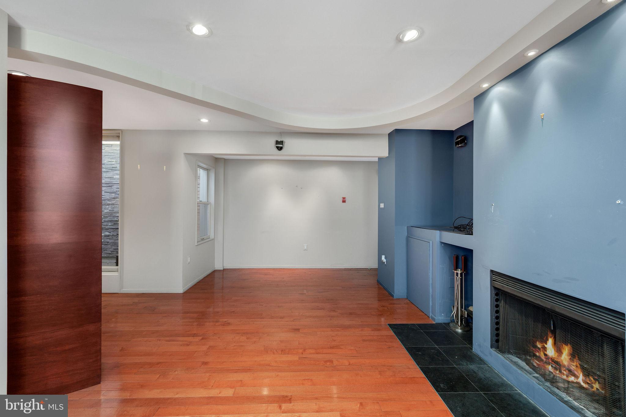 721 D Street Northeast Washington, DC 20002 - Photo 7 of 35 a view of an empty room with wooden floor and a fireplace