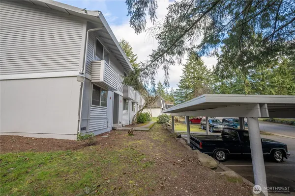 a view of a house with a patio and a yard