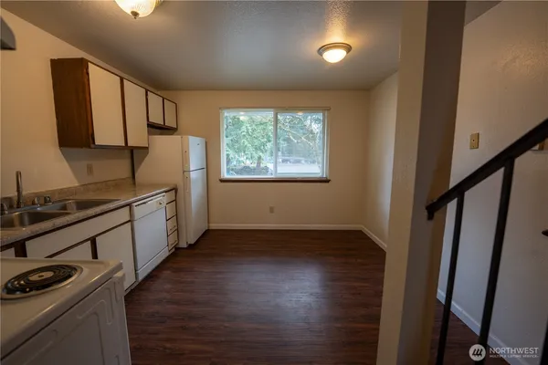a kitchen with sink cabinets and wooden floor