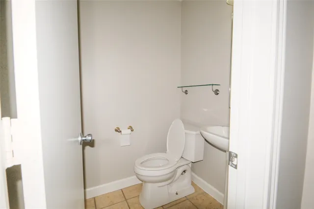 a white toilet sitting next to a shower