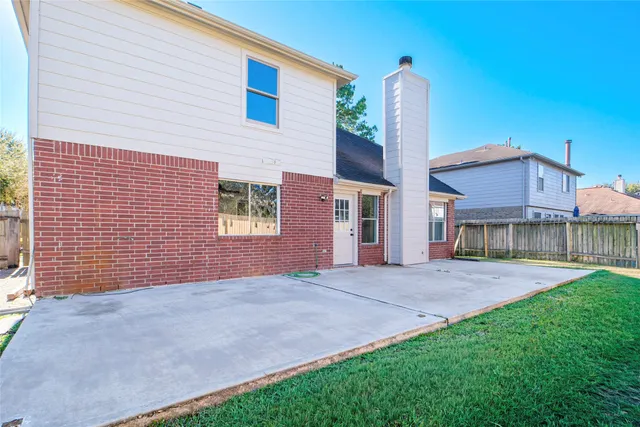 a view of a house with a yard and potted plants