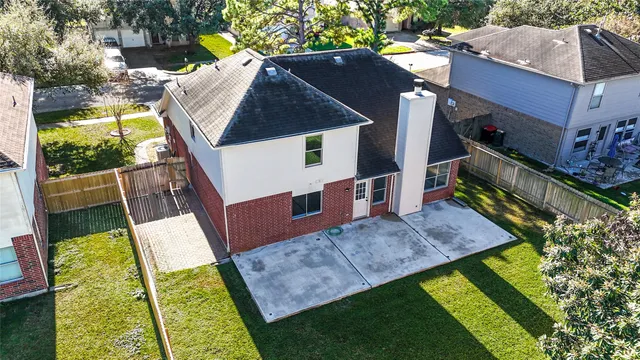 a view of an house with backyard space and balcony