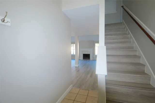 a view of entryway and hall with wooden floor