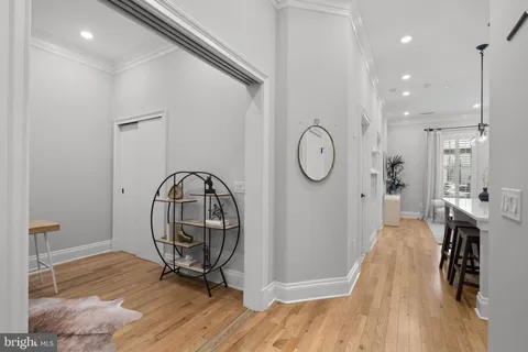 a view of a hallway with wooden floor and entryway