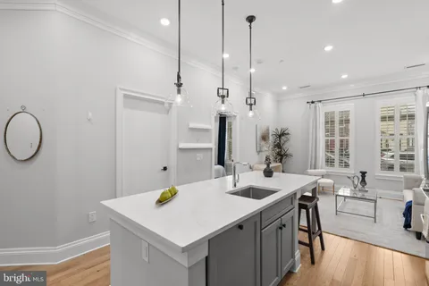 a kitchen with a sink a stove and chairs