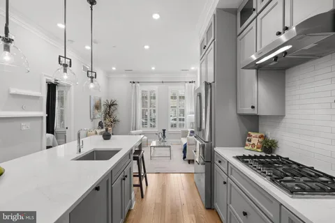 a kitchen with counter top space a sink a stove and refrigerator