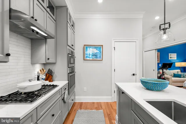 a kitchen with stainless steel appliances granite countertop a sink stove and cabinets
