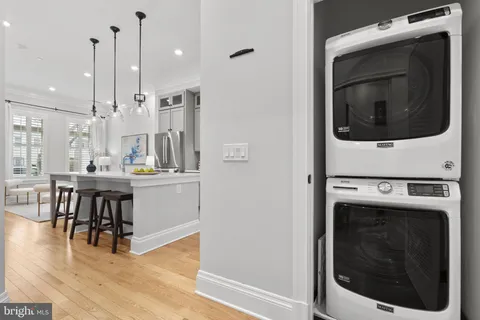 a kitchen with a stove and a wooden floors