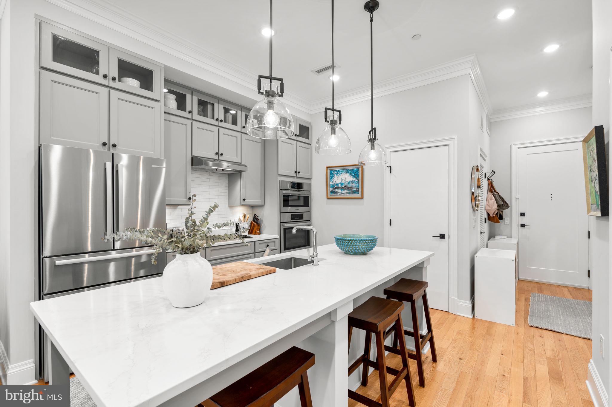300 8th Street Northeast, Unit 102 Washington, DC 20002 - Photo 19 of 29 a kitchen with stainless steel appliances granite countertop a dining table chairs and refrigerator