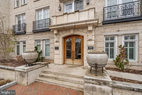 a front view of a building with barbeque grill table and chairs