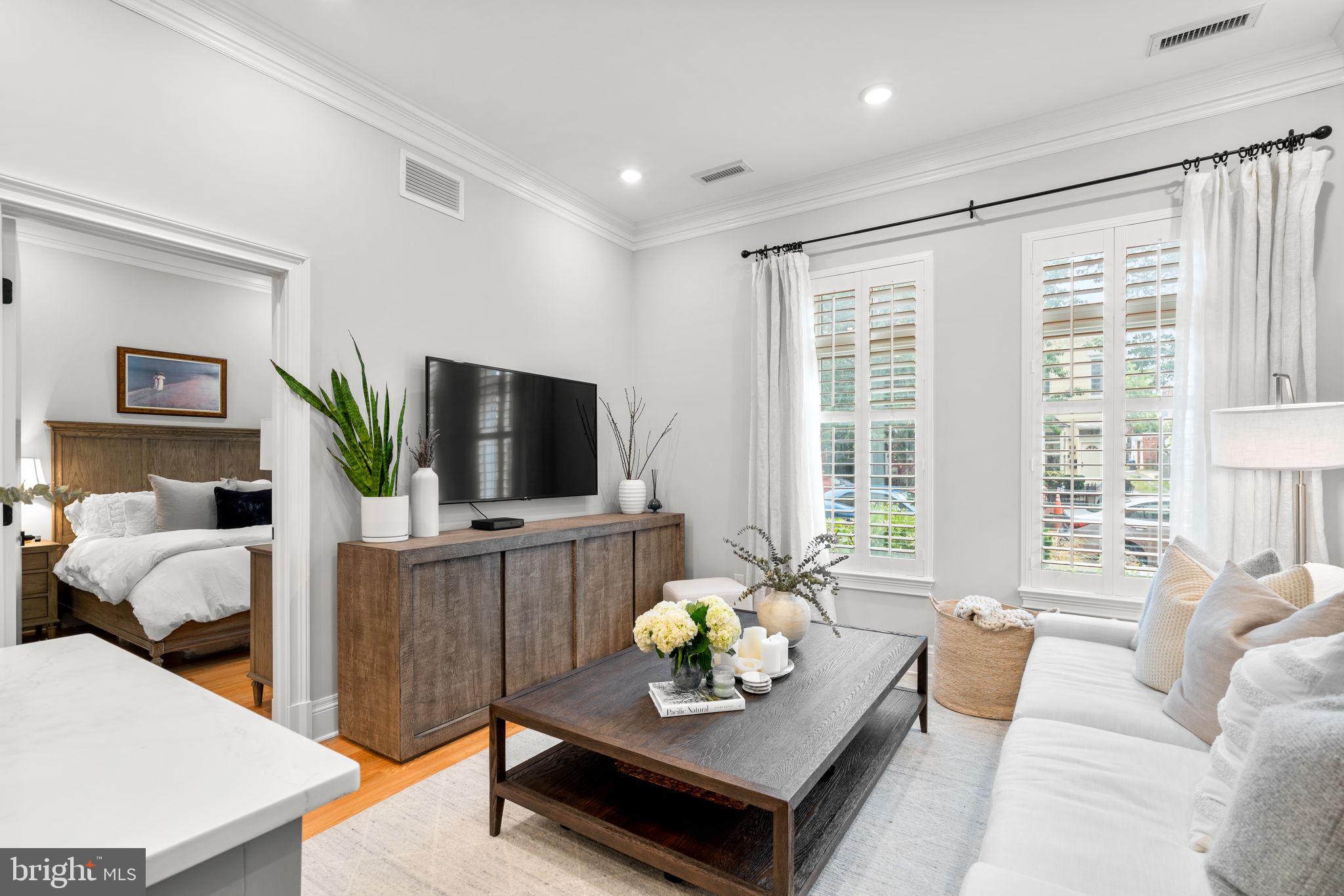 300 8th Street Northeast, Unit 102 Washington, DC 20002 - Photo 22 of 29 a living room with furniture and a flat screen tv