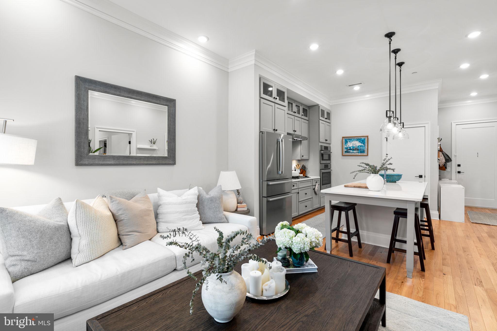 300 8th Street Northeast, Unit 102 Washington, DC 20002 - Photo 24 of 29 a living room with furniture kitchen view and a wooden floor
