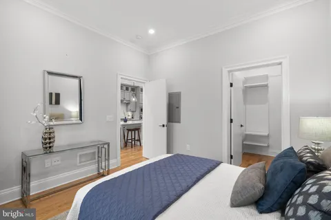 a bedroom with a bed and a large mirror