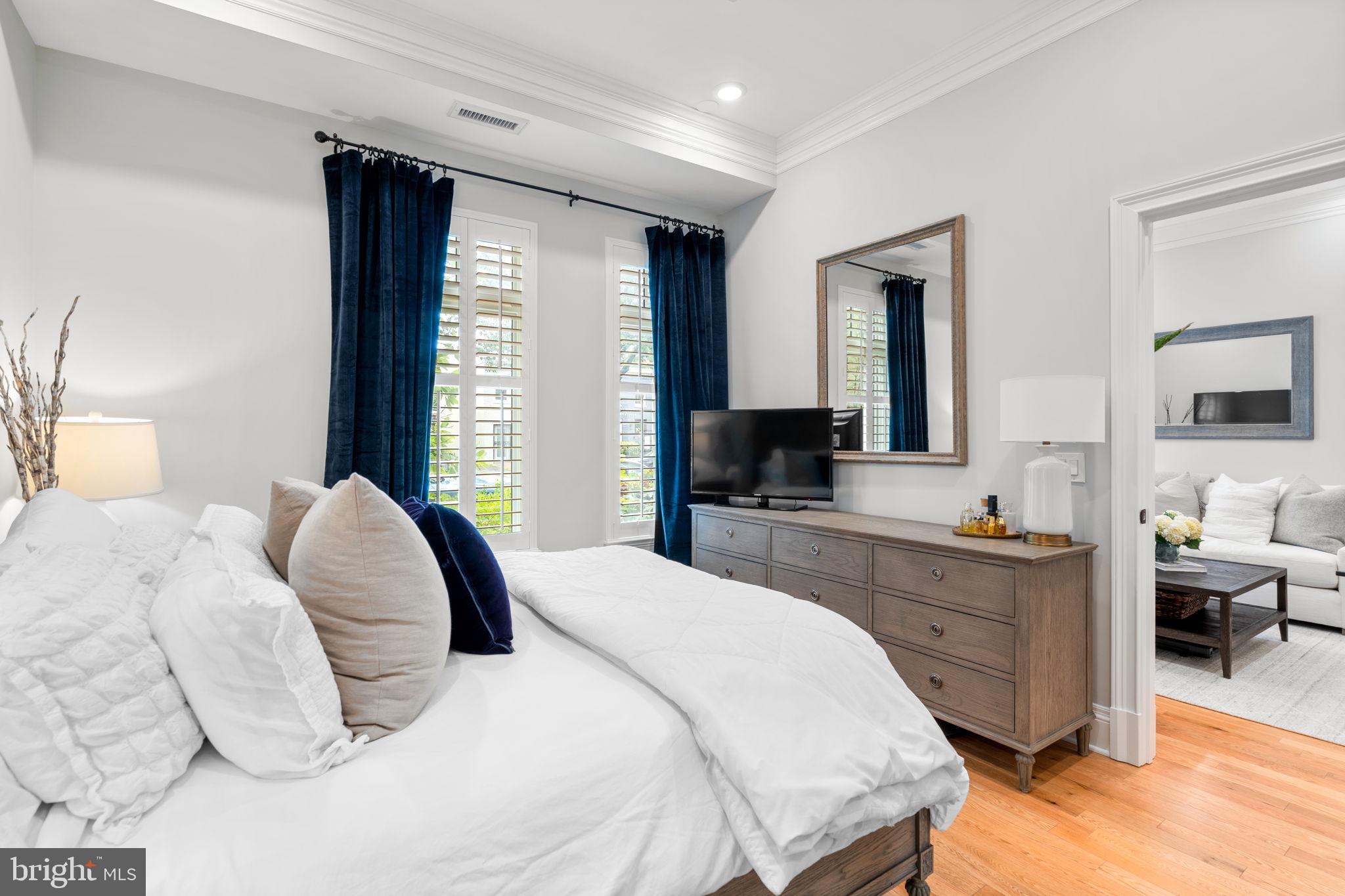 300 8th Street Northeast, Unit 102 Washington, DC 20002 - Photo 27 of 29 a bedroom with a large bed and a flat tv screen