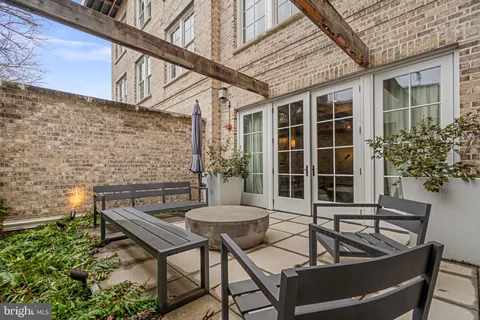 a view of a house with backyard and sitting area