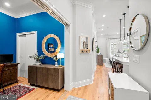a living room with furniture a mirror and a clock