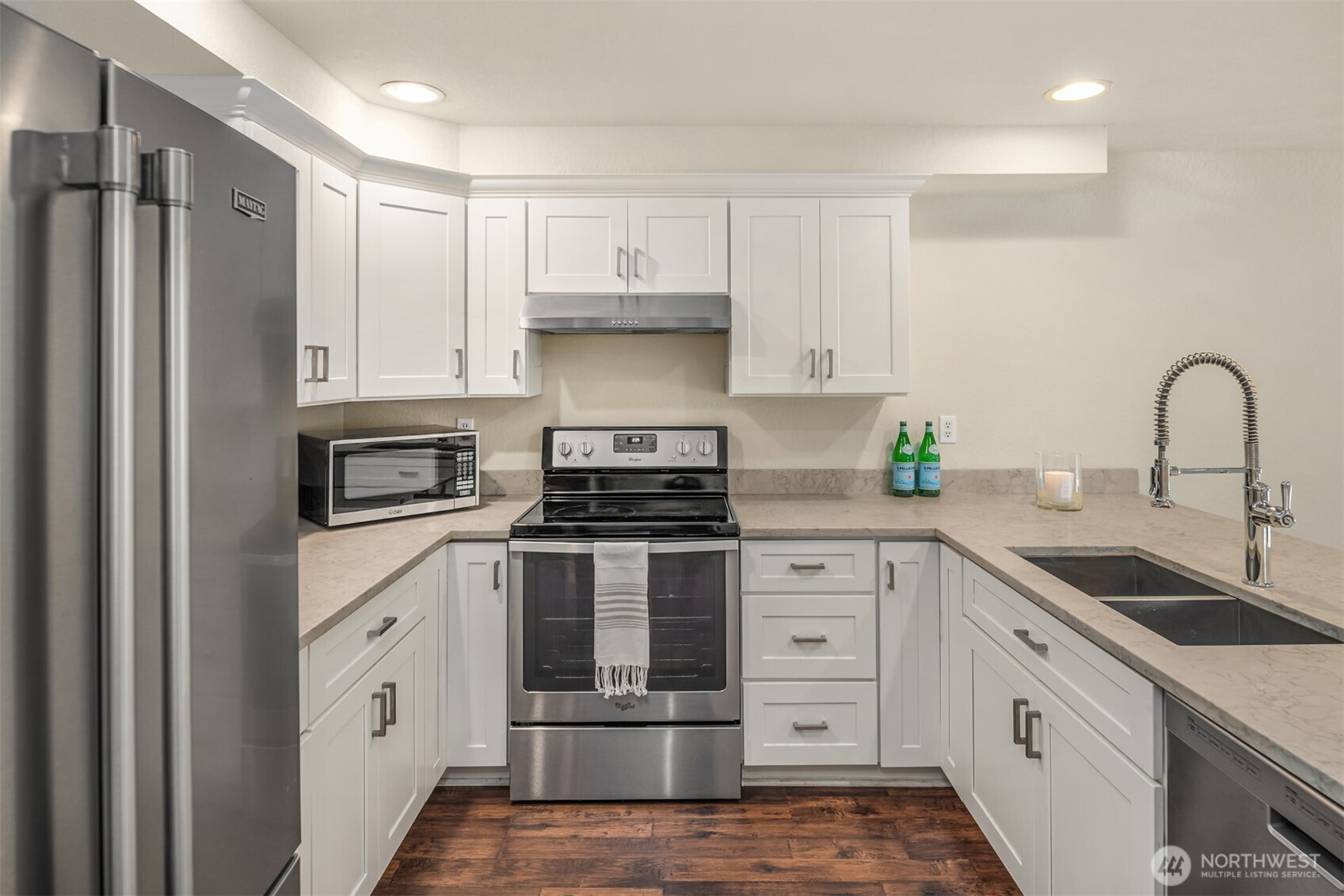 12014 98th Avenue Northeast, Unit 101 Kirkland, WA 98034 - Photo 13 of 33 a kitchen with cabinets stainless steel appliances and a sink